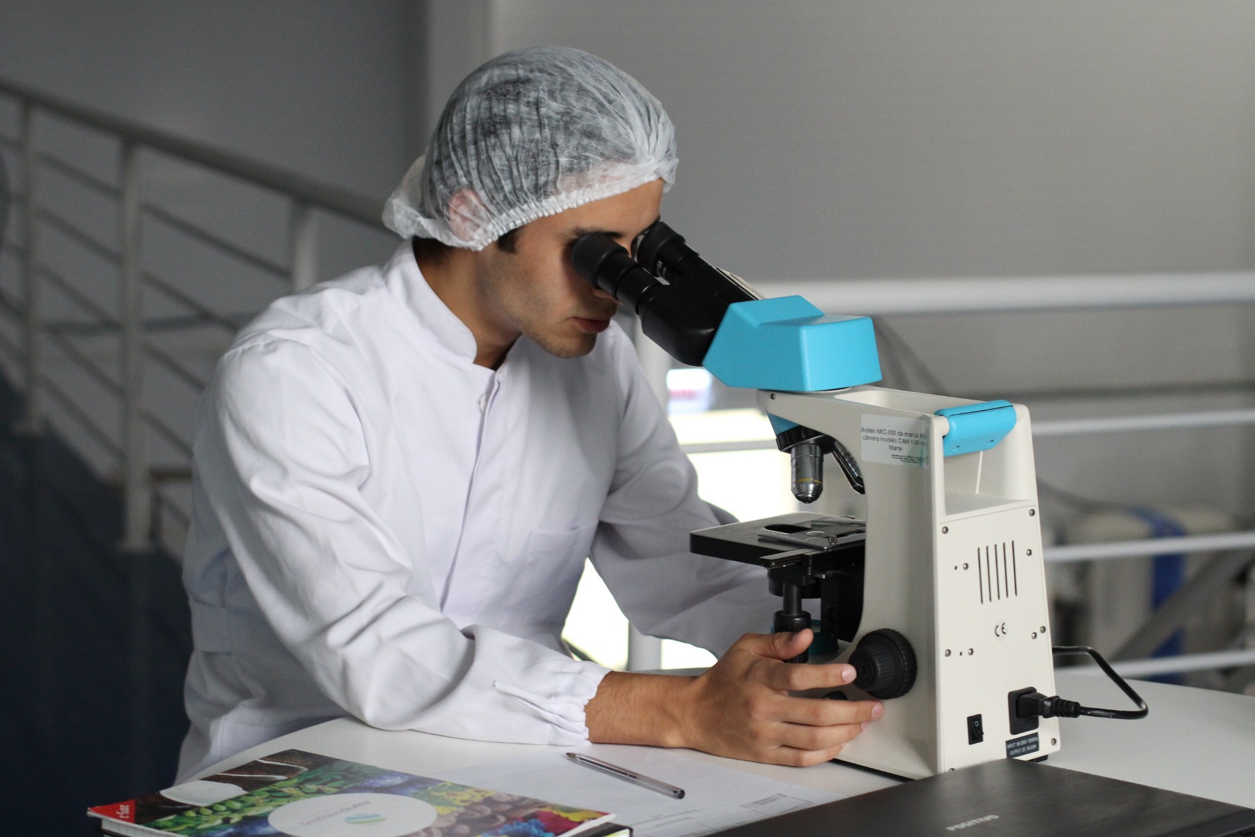 Technician using a microscope. How to protect intellectual property